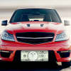 Custom money front license plate on a red car, personalized car decor