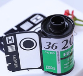 Custom green film roll keychain with photo slots, ideal gift for capturing memories.