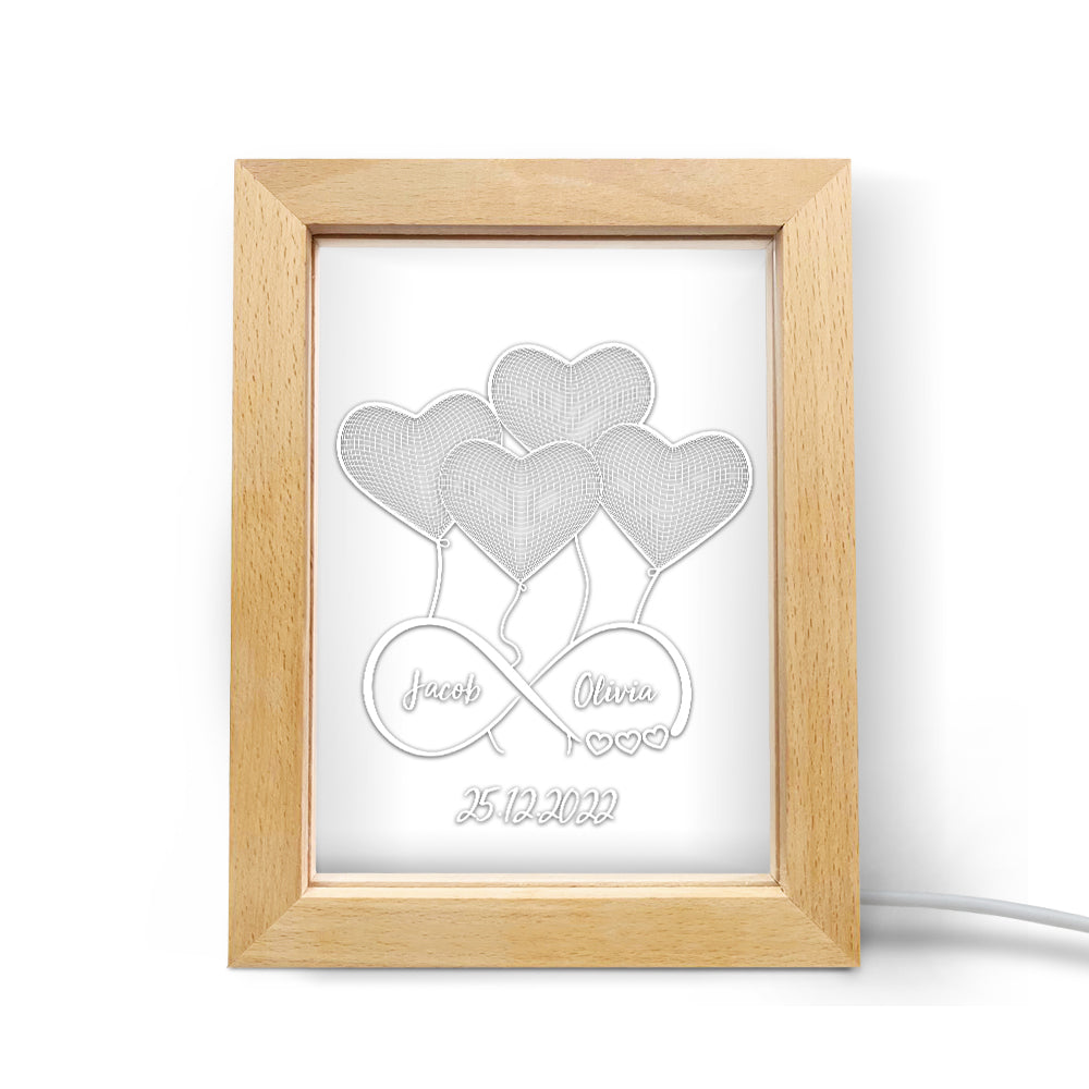 Custom night light with heart design and personalized names, wooden frame, perfect gift.