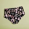 Black high-waist statement panties with 'UP, YES, FUN' text design and star pattern, polyester blend, comfortable fit.