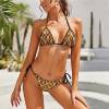 Leopard print bikini swimwear with adjustable straps and side ties, perfect for beach.