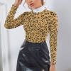 Women's leopard print lapel sweater with white turtleneck, perfect for winter wear.