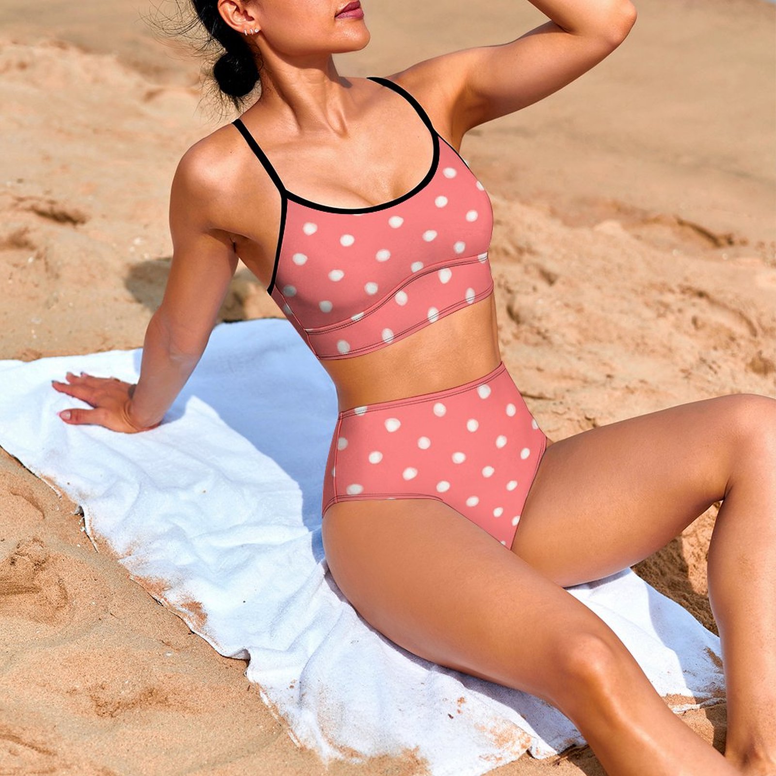 Pink polka dot bikini swimwear with high-waisted bottoms, perfect for beach days.