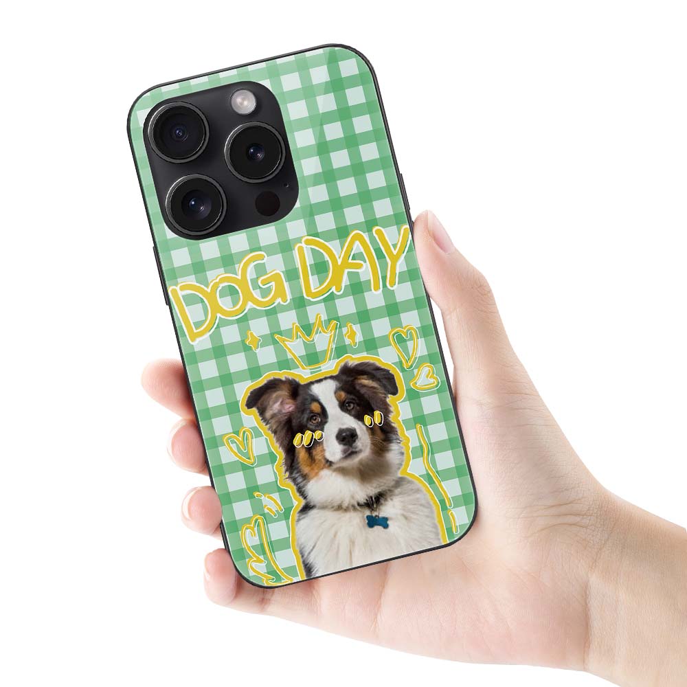 iPhone 15 case with dog graphic and "DOG DAY" text on a green gingham pattern, Glass + TPU protection