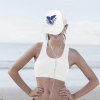 Woman wearing a white baseball cap with a blue bird and sword graphic, mesh back, perfect for outdoor activities, Inkedjoy