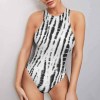 Sleeveless vest jumpsuit in black and white print, versatile and stylish.