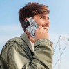 Man using iPhone 15 case with floral pattern, card slot design, stylish and full protection.