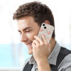 Man using iPhone 15 with beige and pink floral pattern PC case