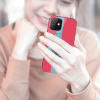 Woman holding iPhone 12 Pro with red and blue glass case, showcasing anti-fall protection and DIY design.
