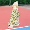 Dog wearing a classic style sunflower pattern pet shirt made of breathable polyester, outdoor sun protection.