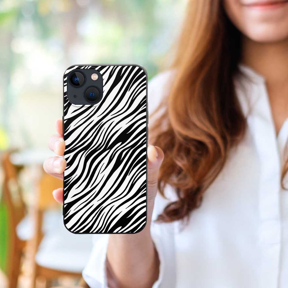 iPhone 13 phone case with black and white zebra print, held by a woman, TPU material, scratch-resistant