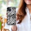 iPhone 13 phone case with black and white zebra print, held by a woman, TPU material, scratch-resistant