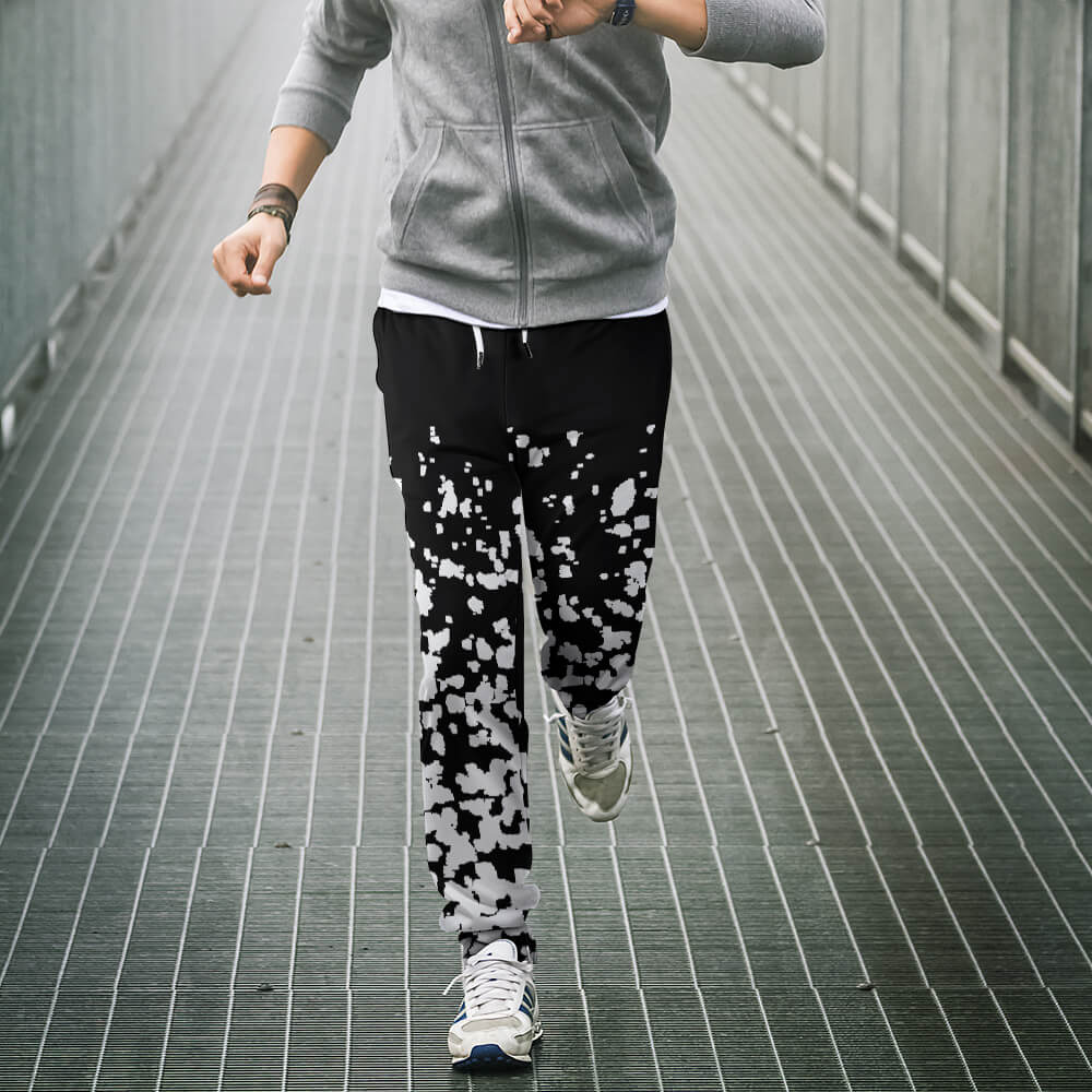 Black and white patterned polyester sweatpants for casual wear, showcasing design and fit during a run.
