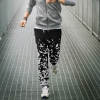 Black and white patterned polyester sweatpants for casual wear, showcasing design and fit during a run.