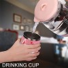 Pink stainless steel insulated cup being filled with water, Inkedjoy drink cup.