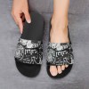 Black PVC home slippers with unique pattern, durable and comfortable, for home, beach, and pool wear.