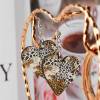 Heart-shaped wooden earrings with leopard print, ideal for daily wear and special occasions. Inkedjoy product.