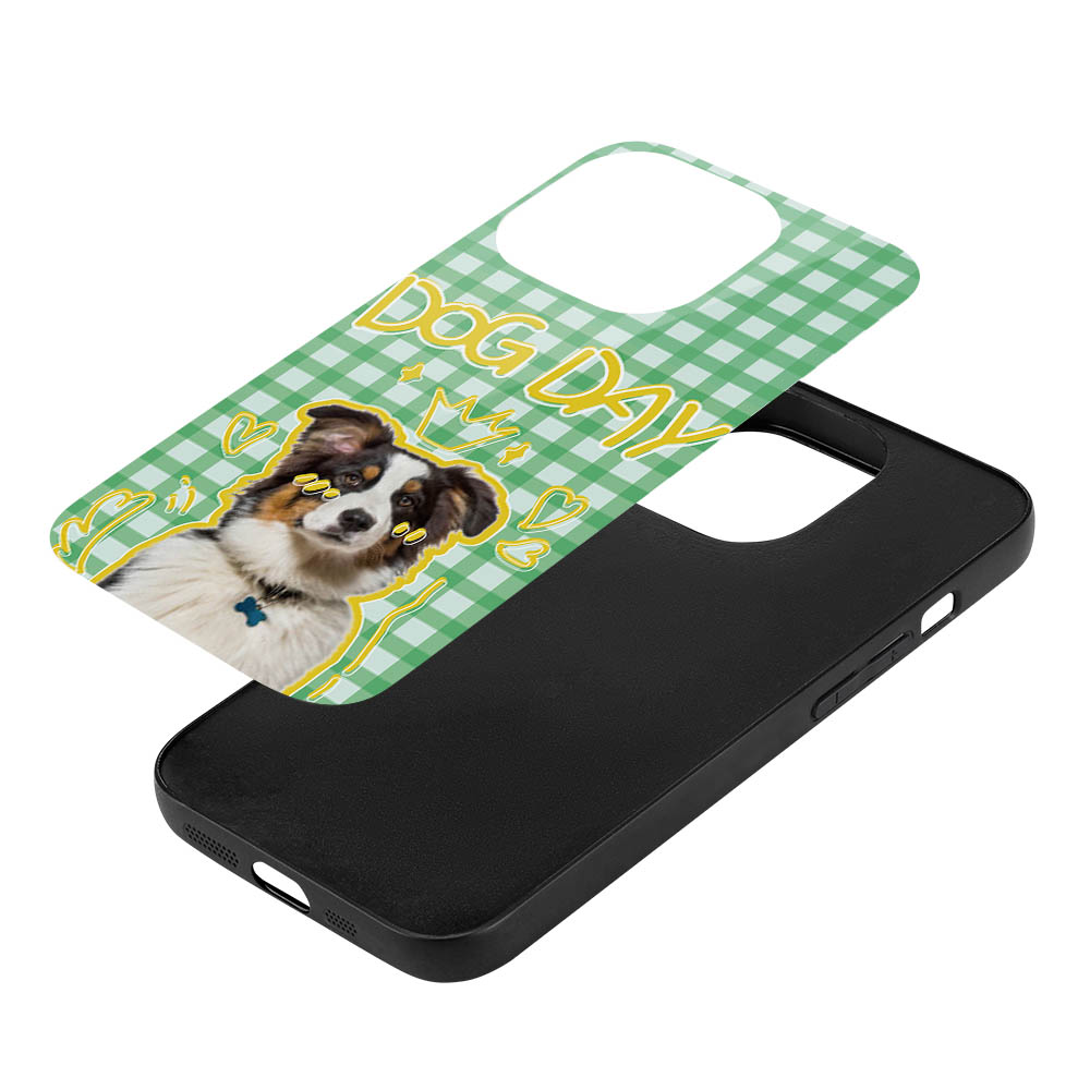 iPhone 15 case with dog graphic and "DOG DAY" text on a green gingham pattern, glass + TPU material.