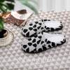 Cow pattern cotton slippers, rubber sole for comfortable indoor wear.