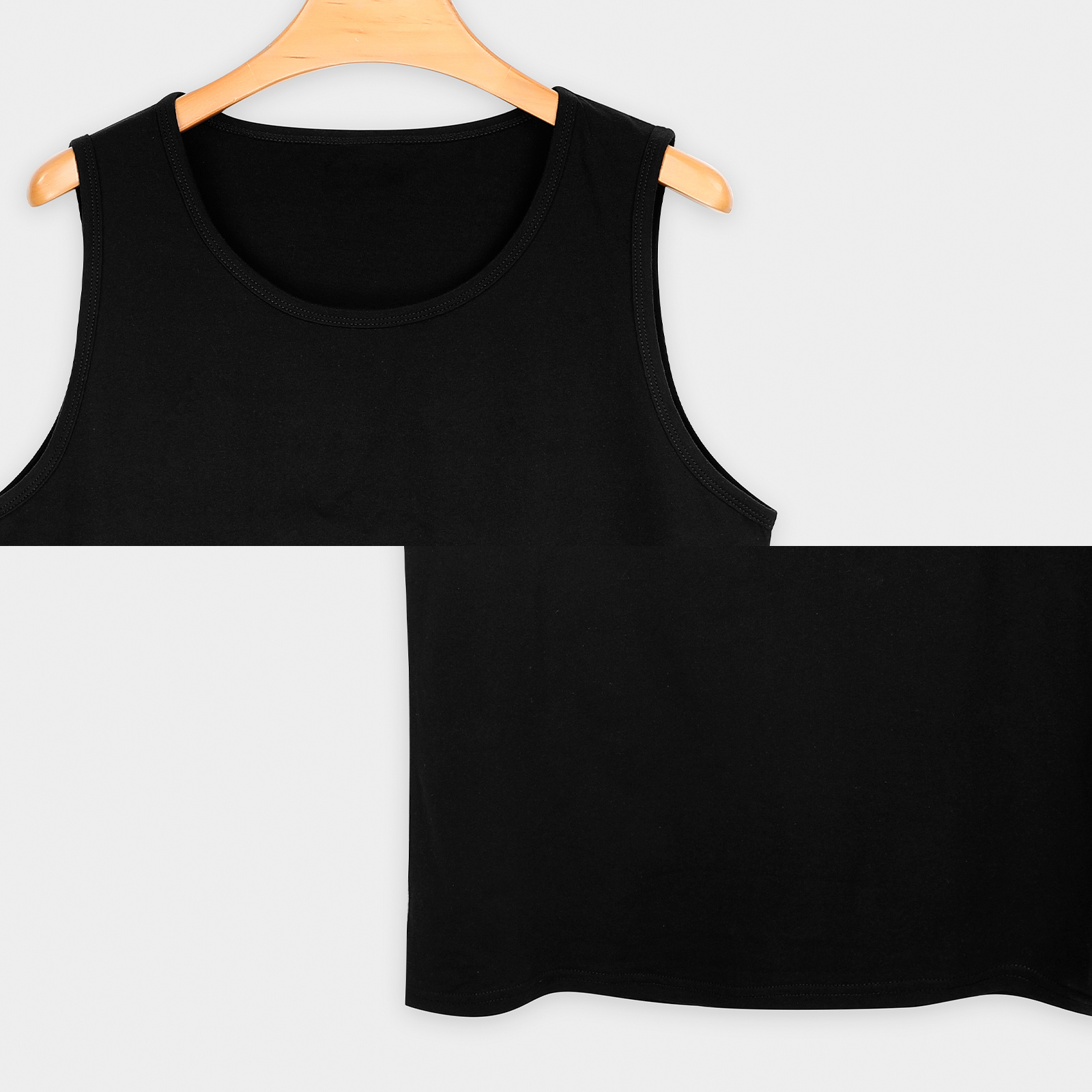 Black cotton tank top on a hanger, perfect for sports and daily wear. Made of 100% cotton.