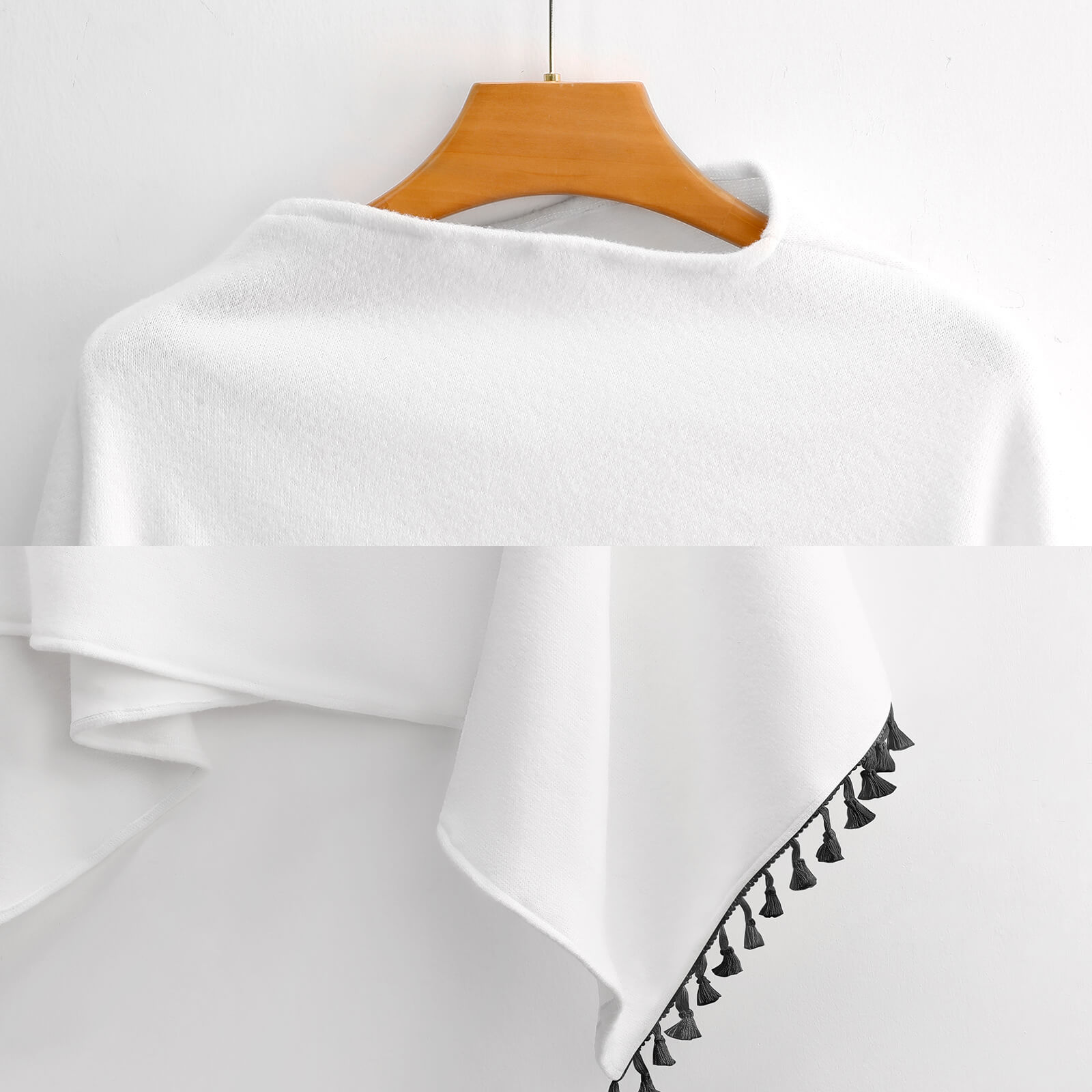 White knitted cape with fringed edge, made of polyester, perfect for casual wear and parties.