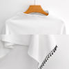 White knitted cape with fringed edge, made of polyester, perfect for casual wear and parties.
