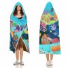 Cloak Hooded Blanket featuring an underwater coral scene, perfect for cozy lounging in Arctic Velvet material