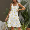 White beach sling skirt with yellow floral print, suitable for party or vacation