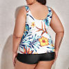 Plus size split swimsuit for women, featuring a white floral print top and black shorts, comfortable and stylish swimwear.