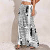 Women's wide-leg pants in black and white newspaper print, made of polyester, high-waisted design.