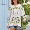 White long sleeve crew neck t-shirt with unique green pattern, polyester-cotton blend for everyday wear.