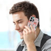 Man using iPhone 15 with pink floral pattern PC case, precise cutouts, scratch-resistant