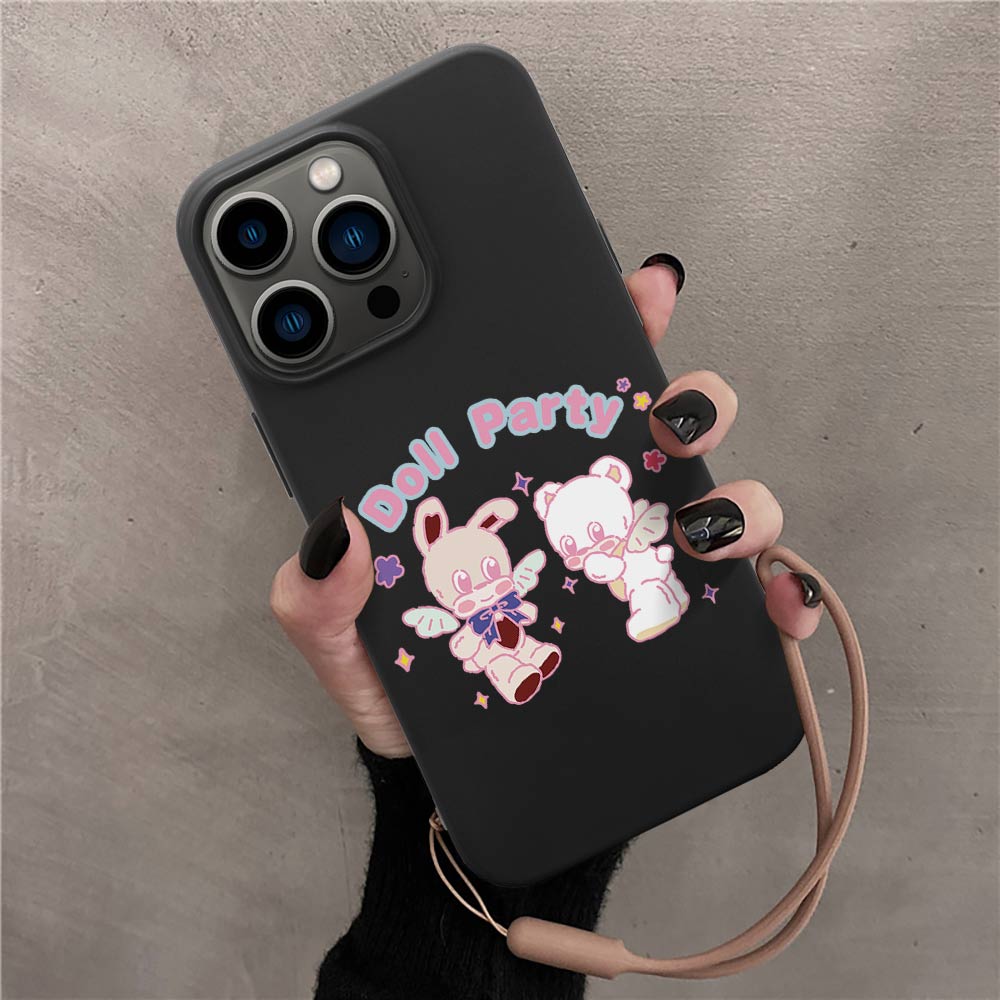 iPhone 13 case, black TPU with "Doll Party" bunny and bear design, wireless charging compatible, hand strap.