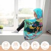 Cozy girl wearing an underwater scene cloak hooded blanket by a window, Arctic Velvet material.