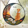 Personalized stained glass suncatcher, memorial gift for dog, with "Oscar" and angel wings, hanging in window.