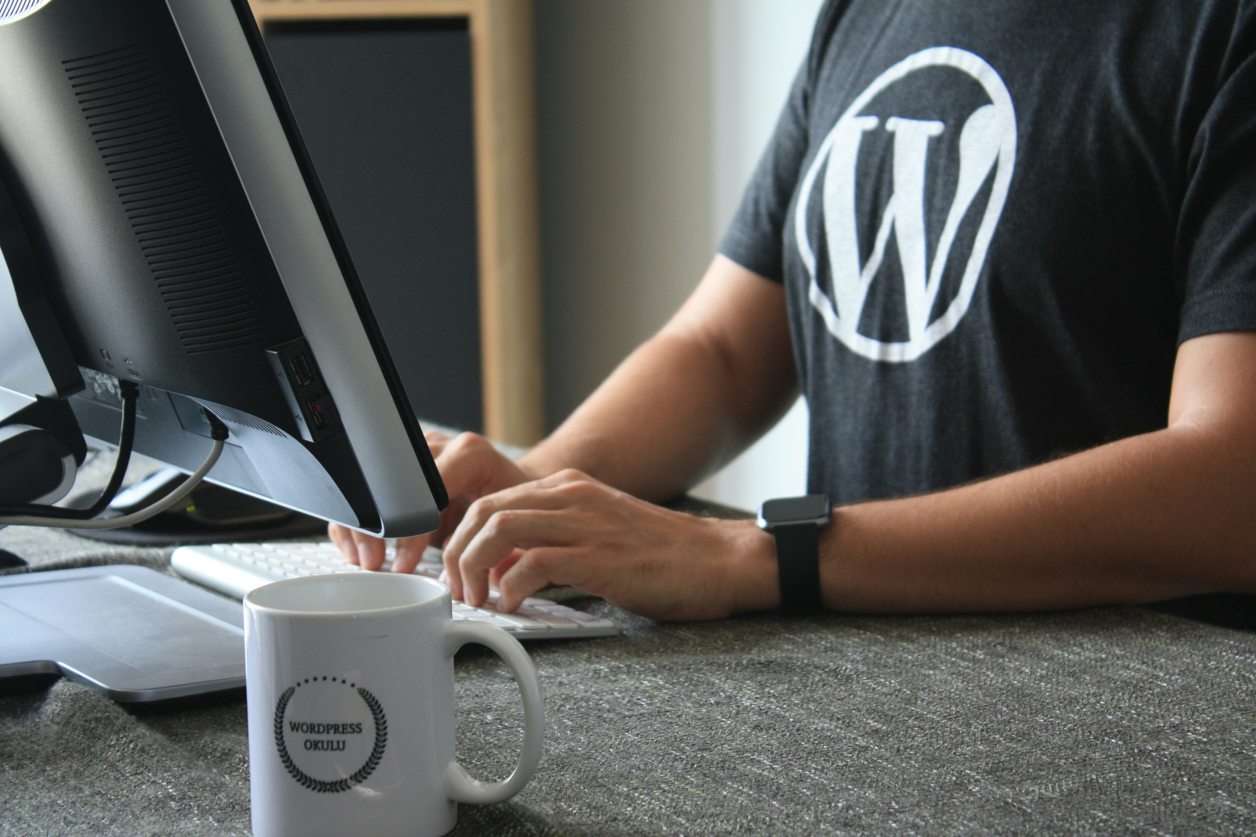 A developer configuring WooCommerce dropshipping integration on a desktop computer.