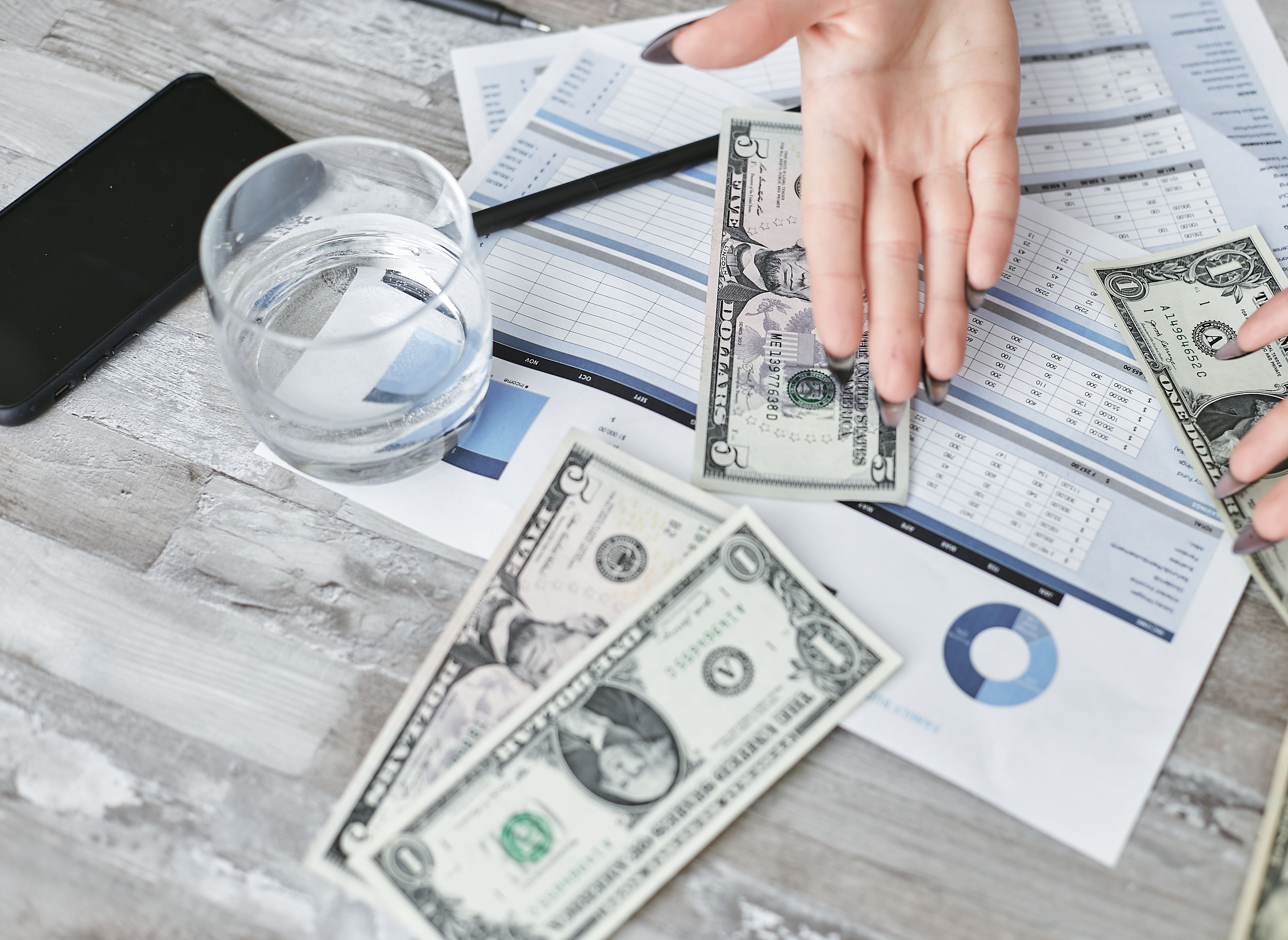 Calculating how much does a product sourcing agent cost while managing business funds over financial reports.