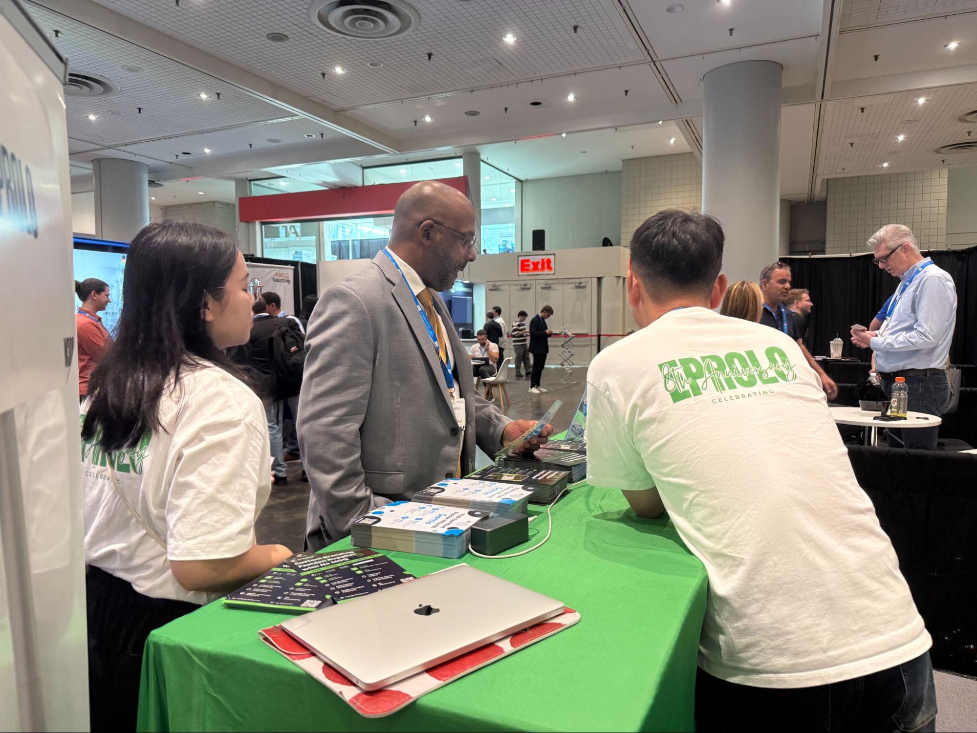 Staff and attendees connecting at the booth
