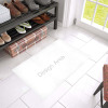 White Azalea doormat with Design Area text, placed in a bright entrance, showcasing the plush sponge material and home decor.