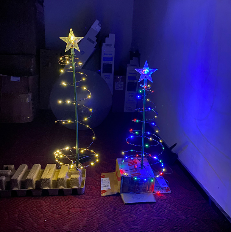Solar LED tree set into the ground in a snowy garden bed