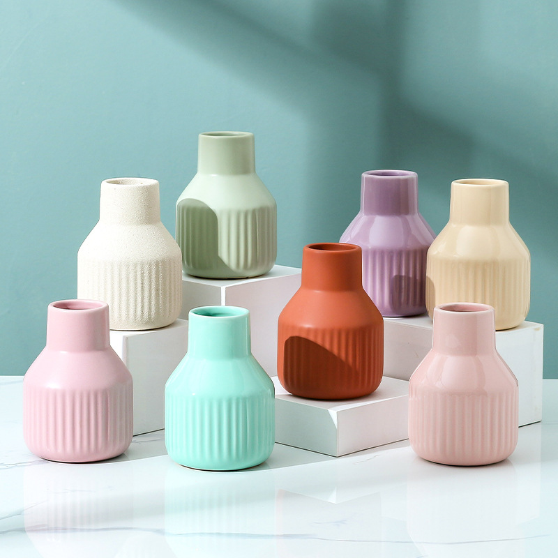 Eight ribbed ceramic vases in matte and glossy pastel finishes