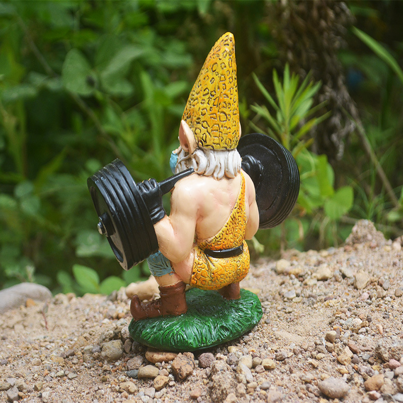 Three-quarter rear view of gnome lifting barbell on a grass base