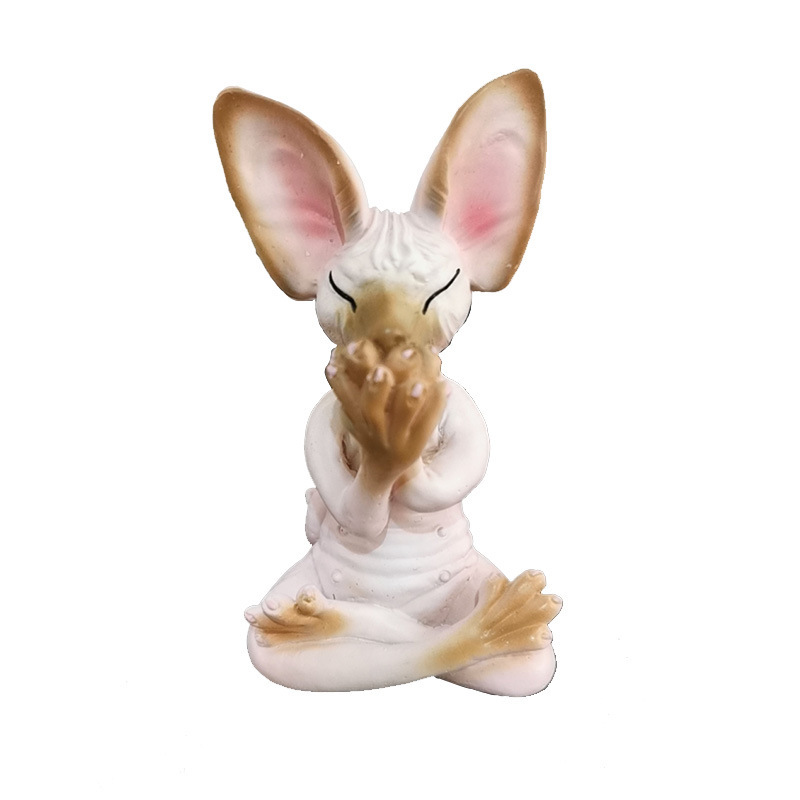 Meditating resin figurine placed on a shelf as a playful accent piece