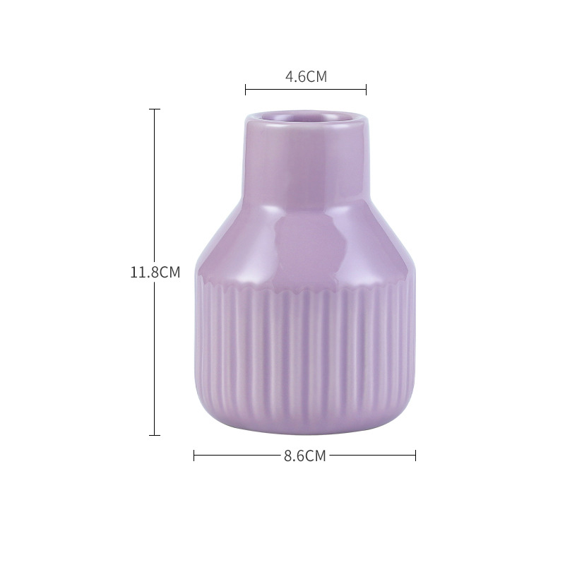 Pastel ribbed ceramic vase placed on a sideboard