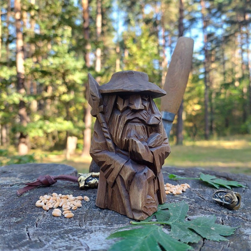 Four carved Norse figures arranged together on a rustic display