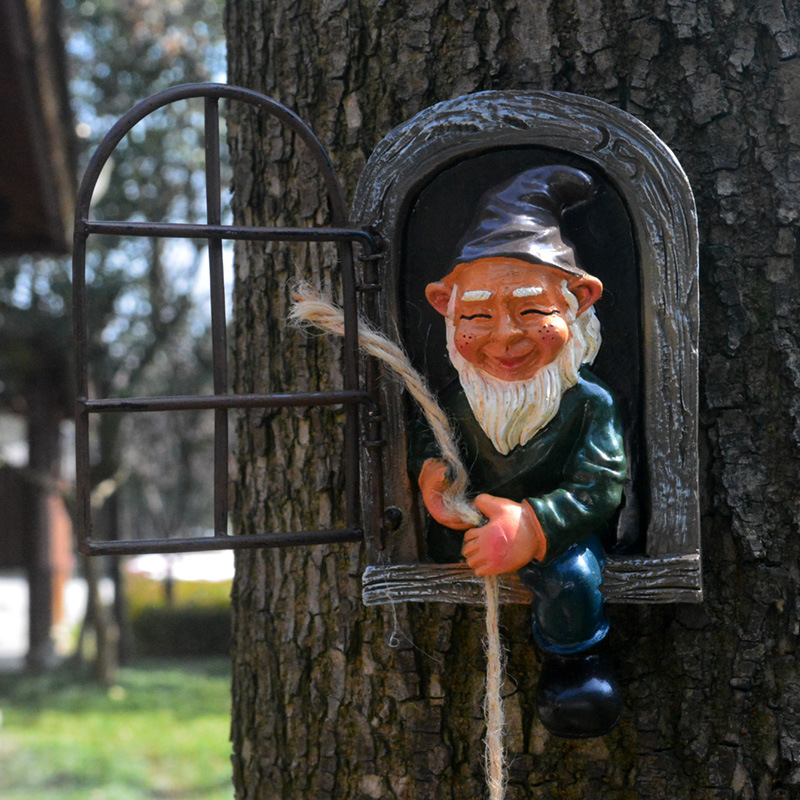 Close-up of window gnome smiling inside arched weathered frame with iron grate