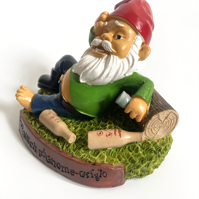 Painted resin garden figure on a textured base outdoors