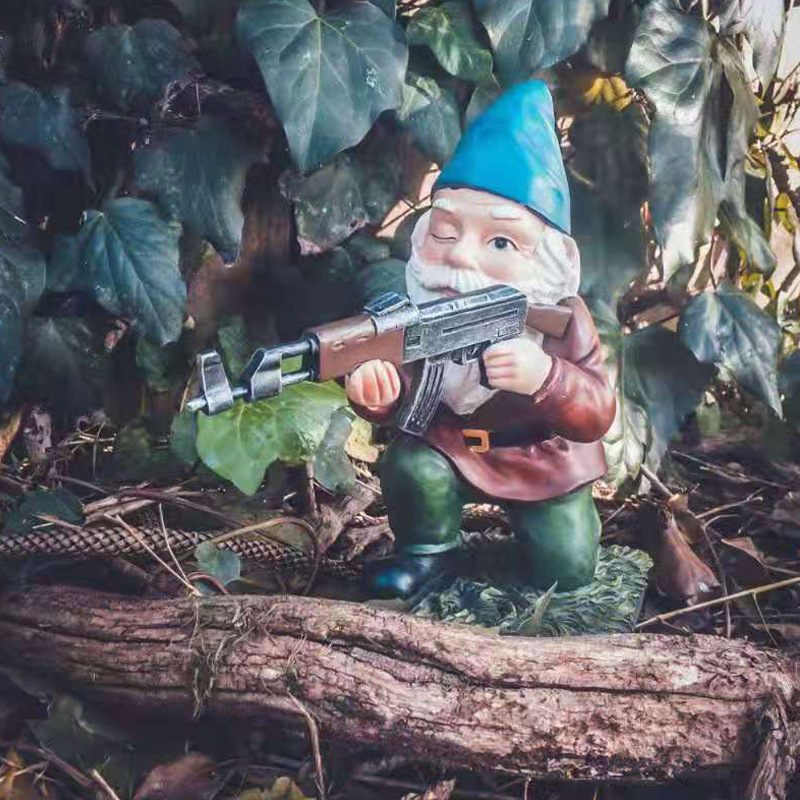 Blue-hatted winking gnome holding a rifle among ivy leaves