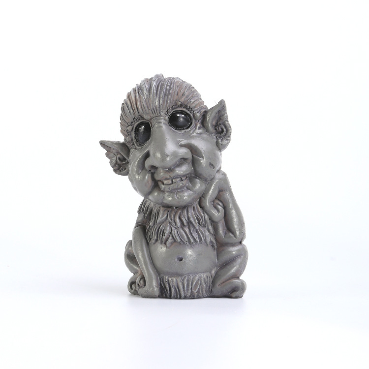 Grey resin troll figurine on plain white background, front view