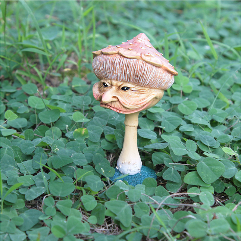 Pink-capped mushroom with a sly grin standing among clover
